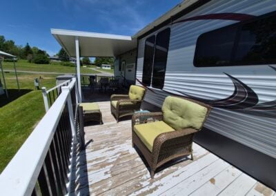 On deck, shows two lounge chairs with the patio table in the background.