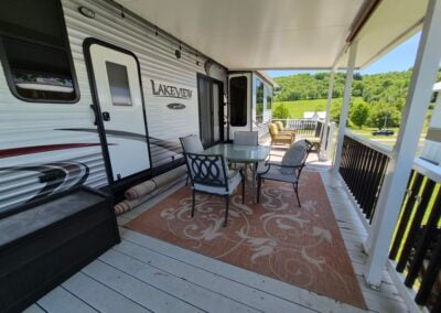 On Deck, shows patio table with four chairs, deck trunk and view of the mountain.