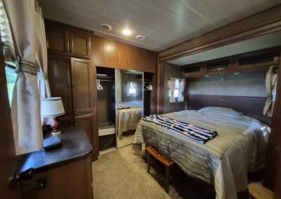 Main Bedroom shows Queen-sized Bed, cabinets, drawers and large closet.