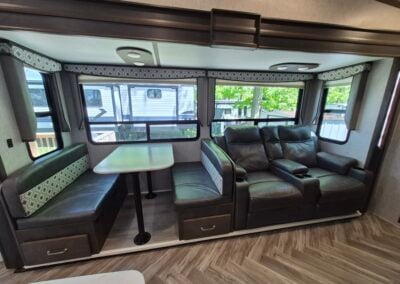 Image of Living/Dining area shows fold-down dining table and two reclining seats.