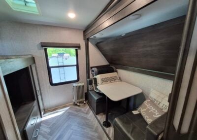 Image of Bunhouse shows bunkbeds on right and bed over storage on the left.