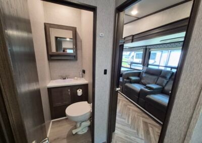 Image in bunkhouse shows entry to half bath and exit to living area.