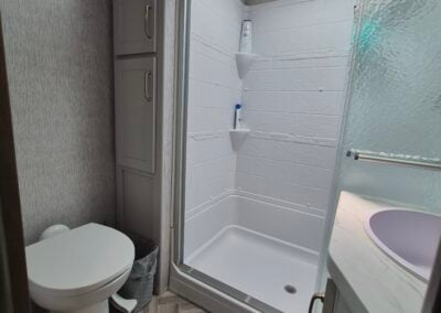 Image of main bathroom shows toilet and shower.