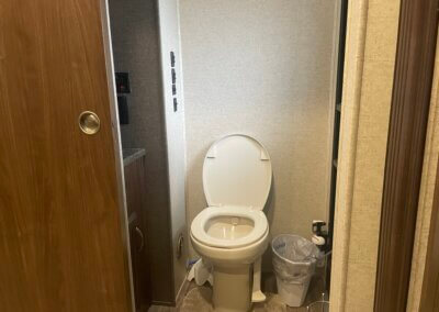 !/2 bath pictured showing toilet, sink, and rear door to the outside.