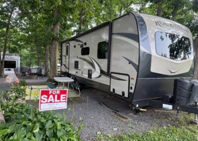 Exterior or Rockwood travel trailer and picnic table with for sale sign