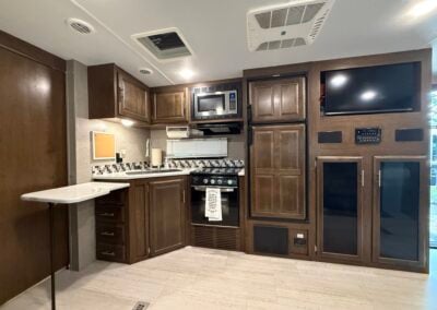 Kitchen sink, stove, fridge, and tv