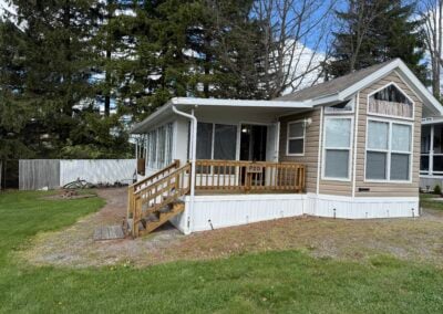 outside of park model with deck and three season room
