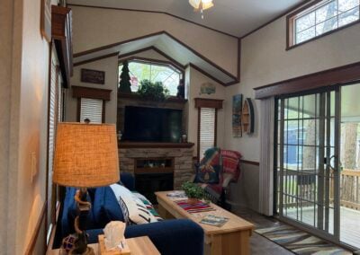 living room with tv and fireplace glass door